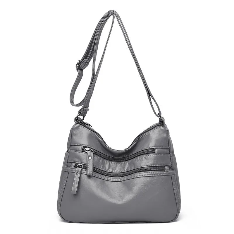 Women's washed leather crossbody bag in solid colour, retro messenger style with adjustable strap and soft handle