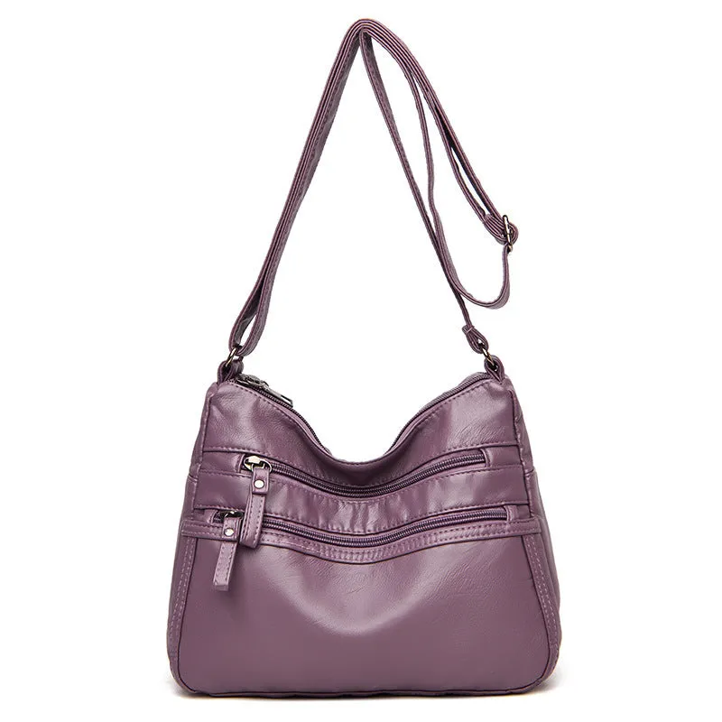 Women's washed leather crossbody bag in solid colour, retro messenger style with adjustable strap and soft handle