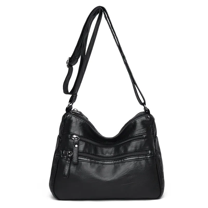 Women's washed leather crossbody bag in solid colour, retro messenger style with adjustable strap and soft handle