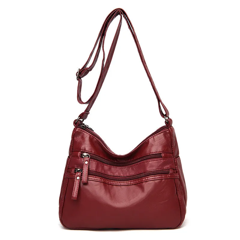 Women's washed leather crossbody bag in solid colour, retro messenger style with adjustable strap and soft handle