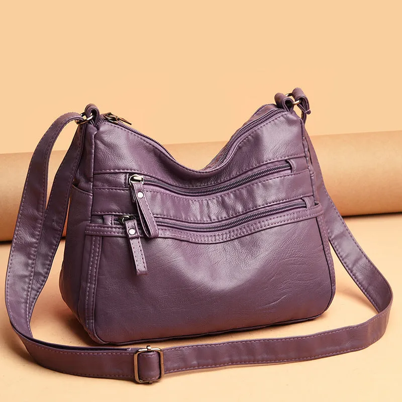 Women's washed leather crossbody bag in solid colour, retro messenger style with adjustable strap and soft handle