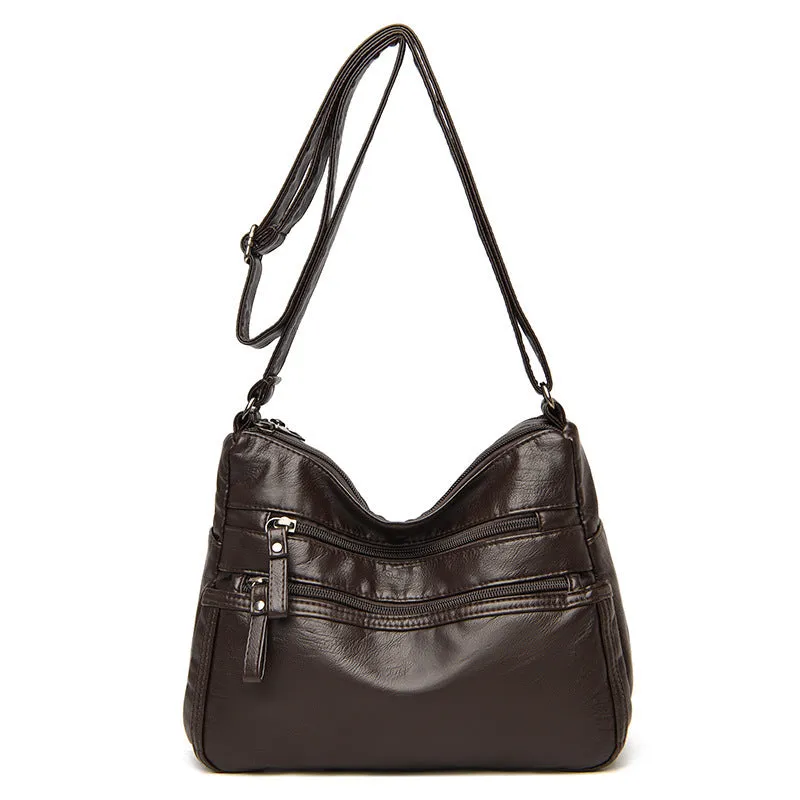 Women's washed leather crossbody bag in solid colour, retro messenger style with adjustable strap and soft handle