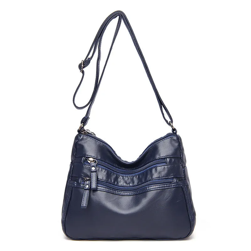 Women's washed leather crossbody bag in solid colour, retro messenger style with adjustable strap and soft handle