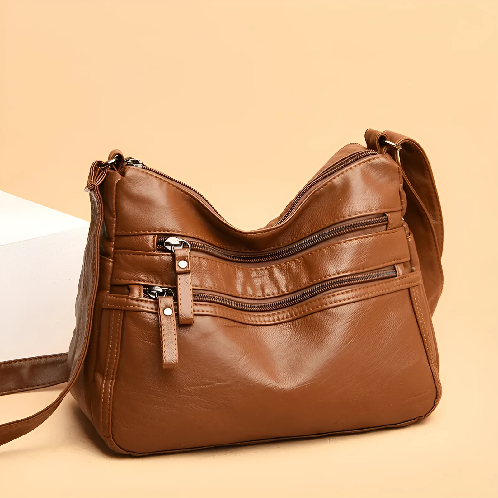 Women's washed leather crossbody bag in solid colour, retro messenger style with adjustable strap and soft handle