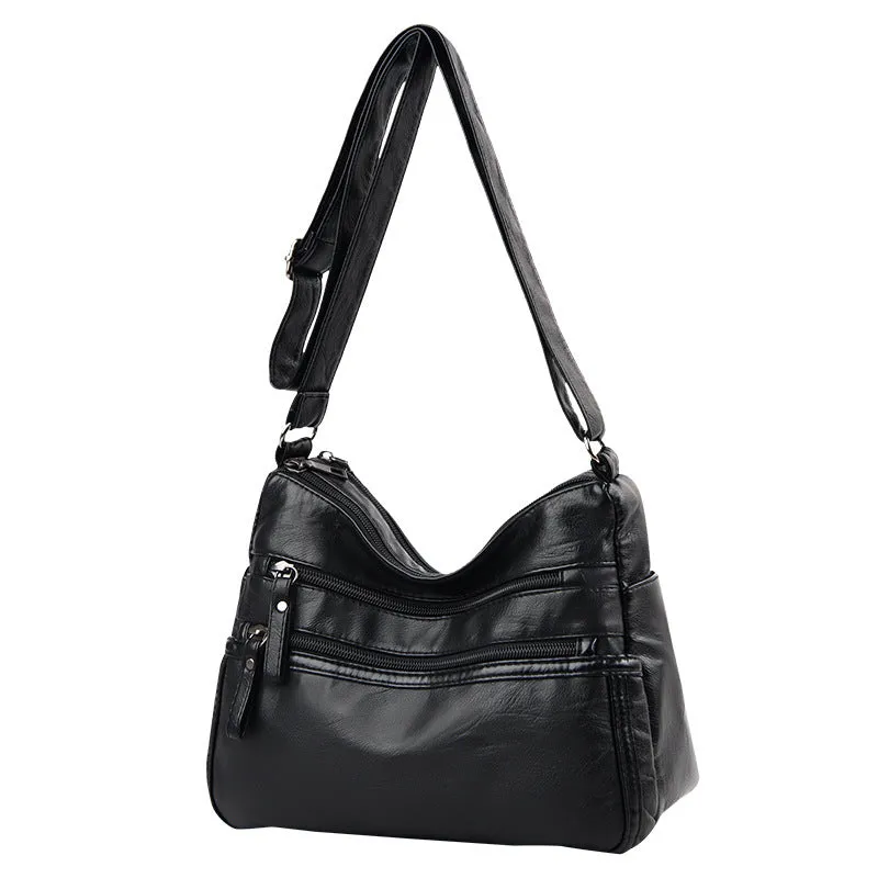 Women's washed leather crossbody bag in solid colour, retro messenger style with adjustable strap and soft handle