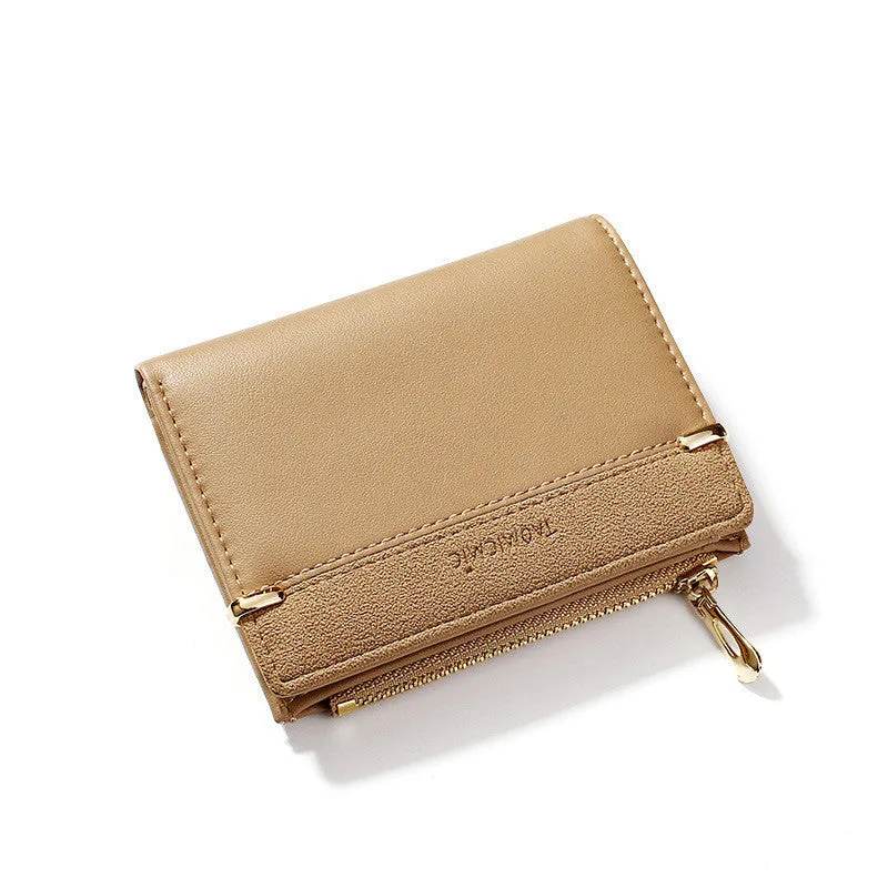 Black ladies bi-fold wallet with a gold zipper, open to show multiple card slots and a coin compartment.