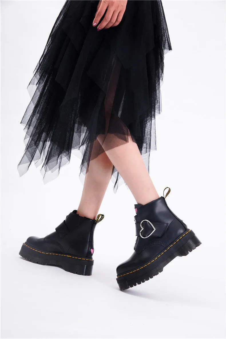 Women's black leather ankle boots with chunky heel, lace-up front, side zip, and belt buckle detail on a waterproof platform