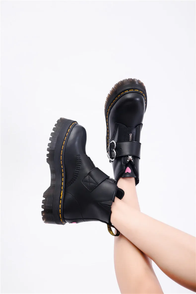 Women's black leather ankle boots with chunky heel, lace-up front, side zip, and belt buckle detail on a waterproof platform