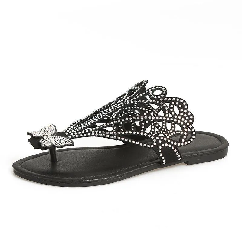 Women's black slip-on sandals with rhinestone decoration and a flip-toe, hollow design.