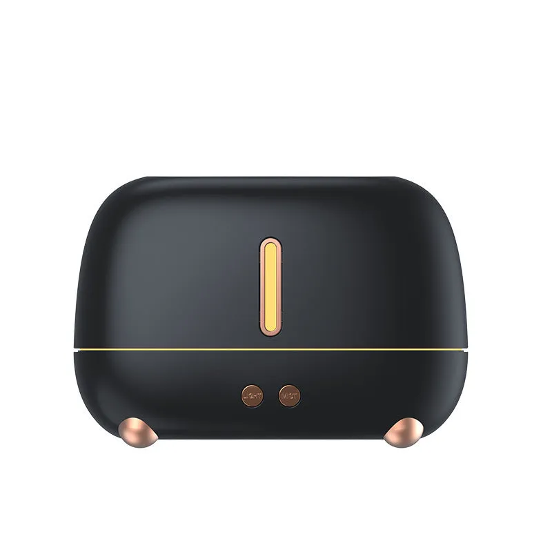 Dark grey flame humidifier with realistic orange LED light and mist output on a wooden table