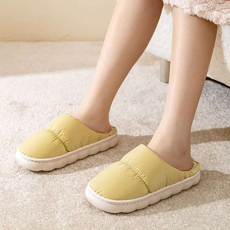 A pair of thick-soled down cotton slippers for men and women in a choice of colours, featuring a non-slip rubber sole.