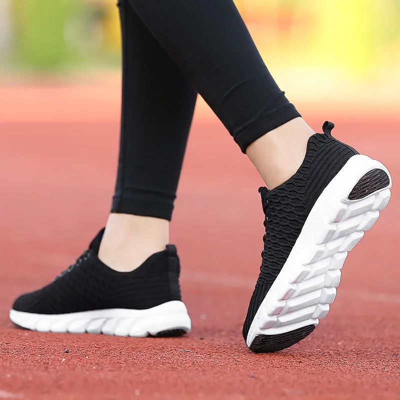 Women's running shoes in black, pink, or white with fly weave upper and durable outsole.