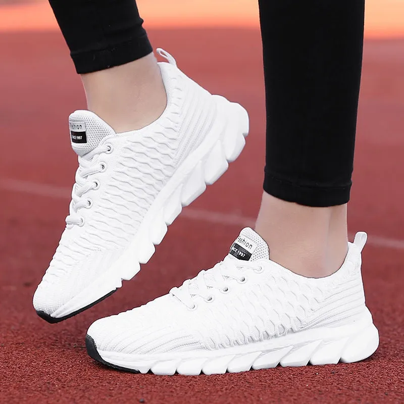 Women's running shoes in black, pink, or white with fly weave upper and durable outsole.