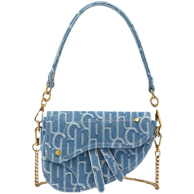 Women's vintage denim saddle bag in blue with cross-body strap and zip pocket interior