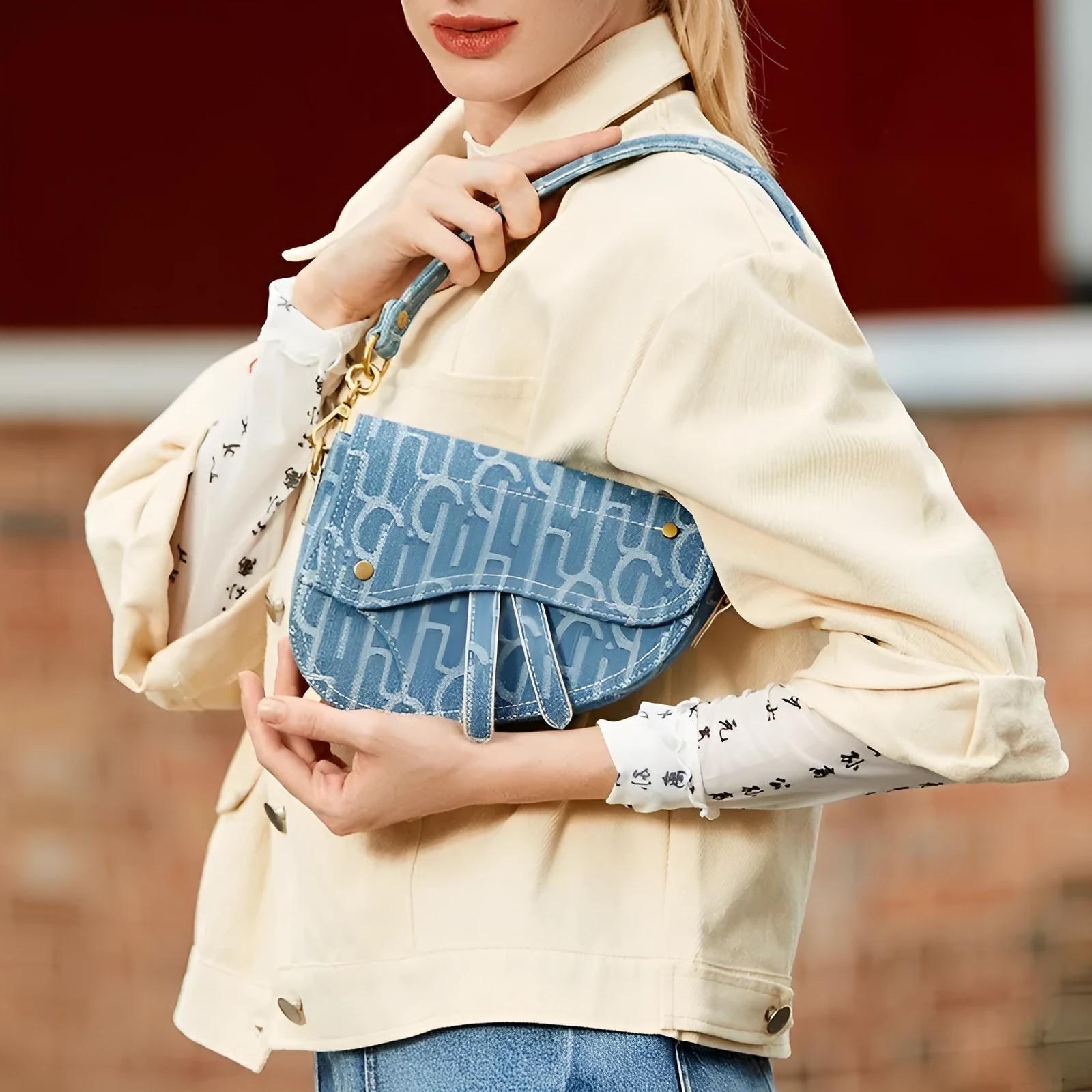 Women's vintage denim saddle bag in blue with cross-body strap and zip pocket interior