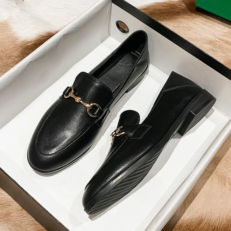 Women's black leather flat shoes with round toe and low heel, side view