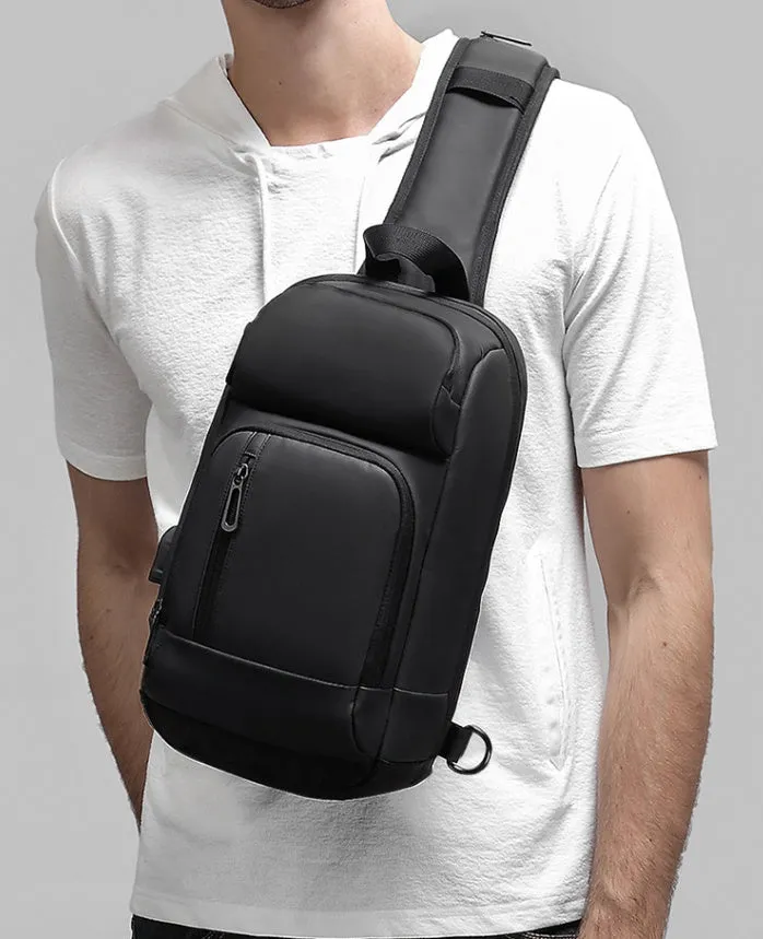 Black PVC outdoor leisure shoulder bag with a single strap, showing dedicated pockets for ID, phone, and computer.
