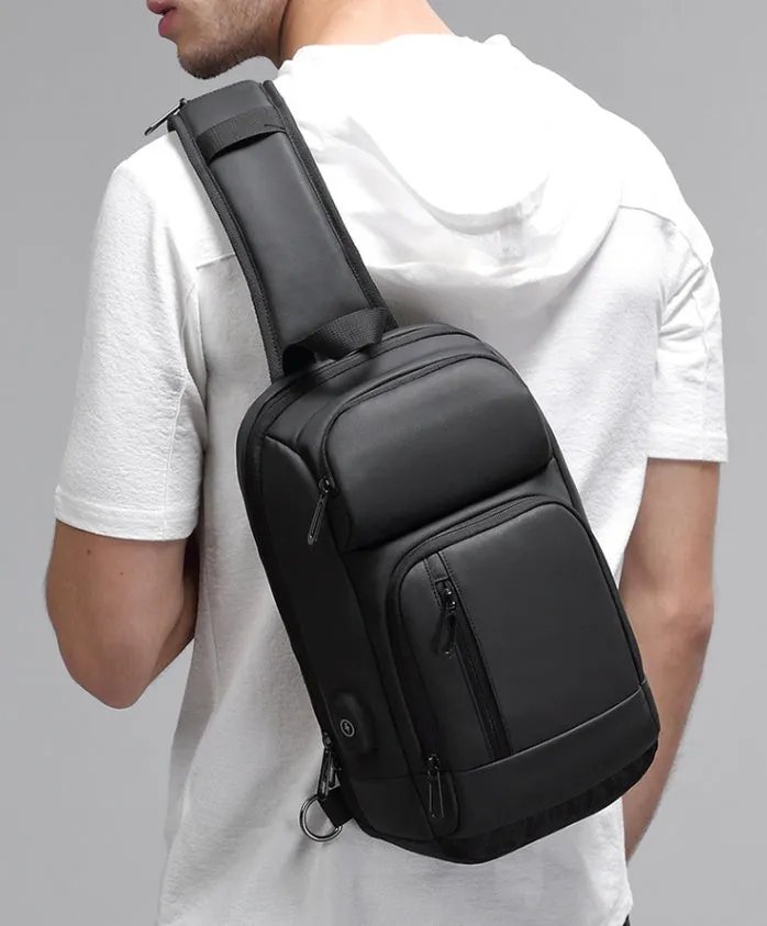 Black PVC outdoor leisure shoulder bag with a single strap, showing dedicated pockets for ID, phone, and computer.