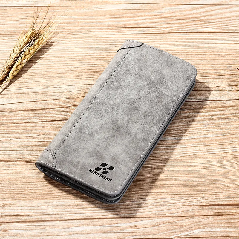 Long men's bi-fold PU leather wallet in brown with car suture stitching, open showing card slots and bill holder