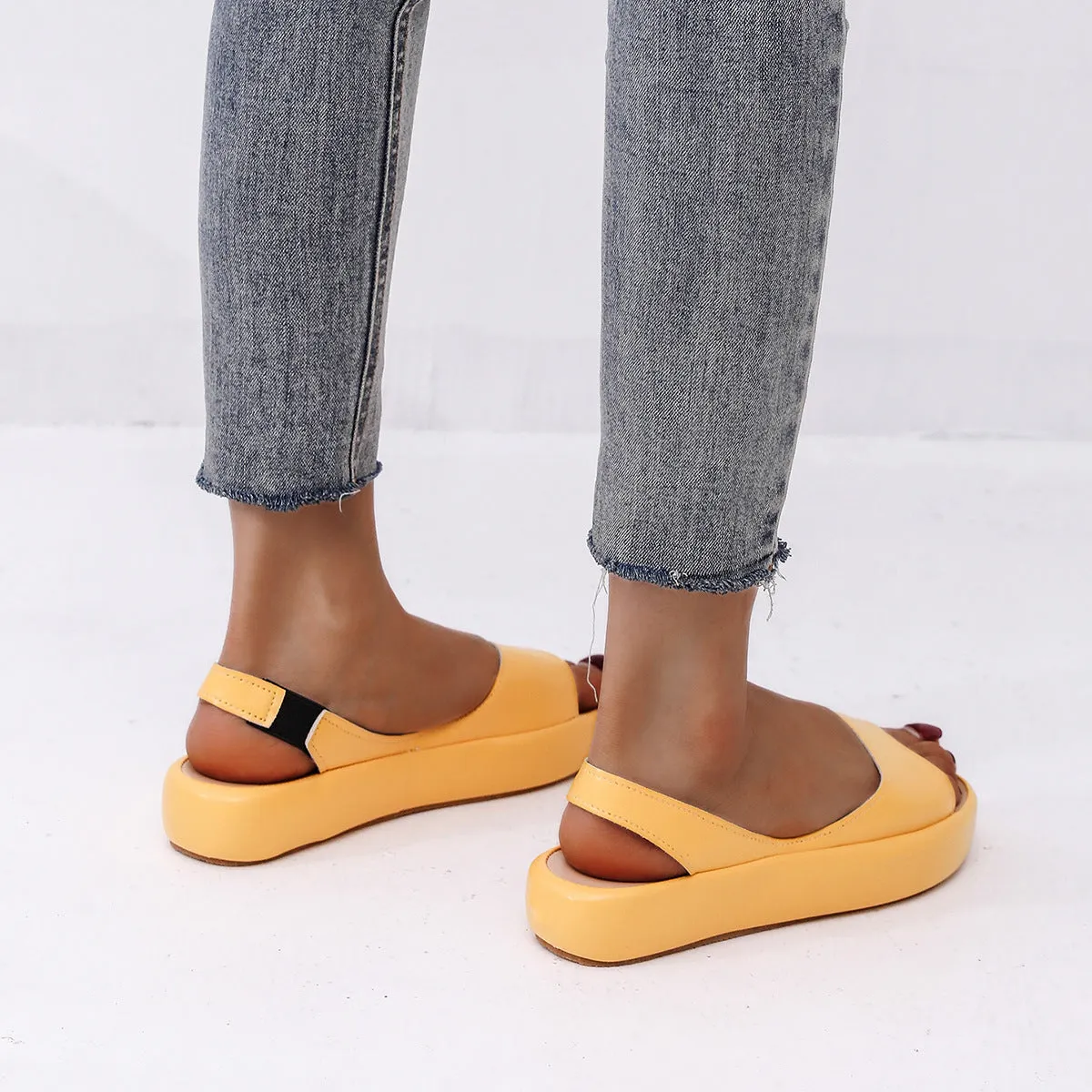 Women's summer fish mouth flat sandals in solid colour with back strap design, side hollow detail, artificial PU upper, rubber sole