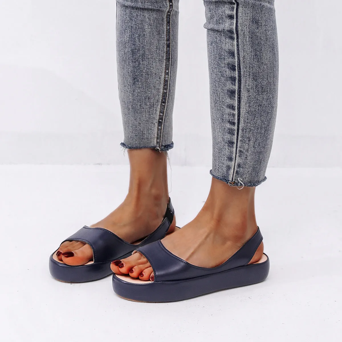 Women's summer fish mouth flat sandals in solid colour with back strap design, side hollow detail, artificial PU upper, rubber sole