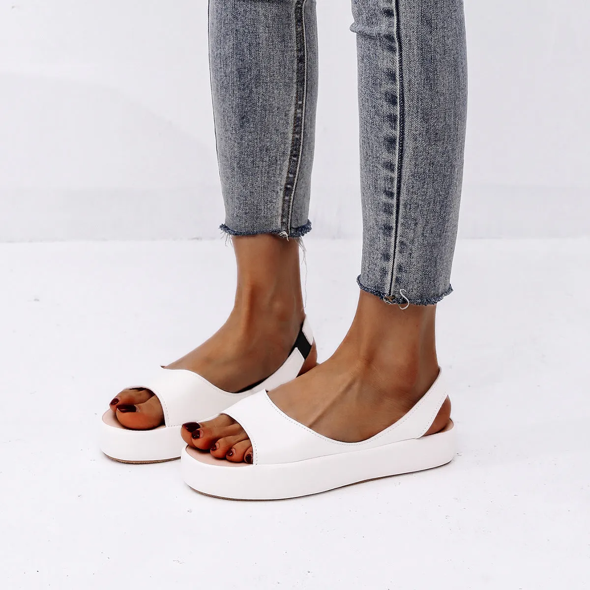 Women's summer fish mouth flat sandals in solid colour with back strap design, side hollow detail, artificial PU upper, rubber sole