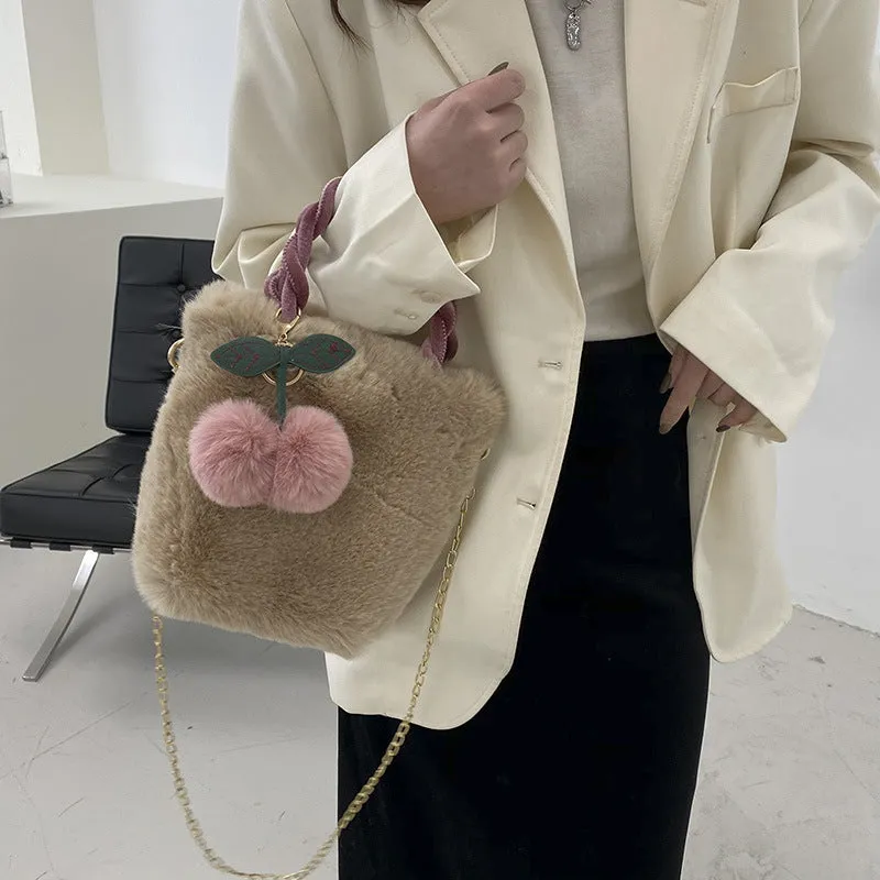 Large soft plush travel bucket bag in beige with open pocket and single shoulder strap