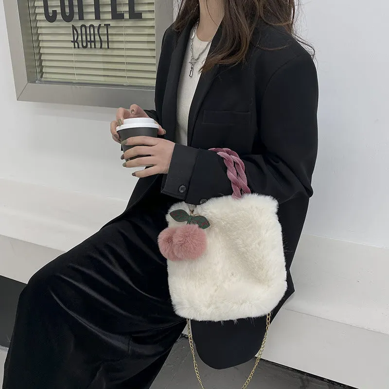 Large soft plush travel bucket bag in beige with open pocket and single shoulder strap