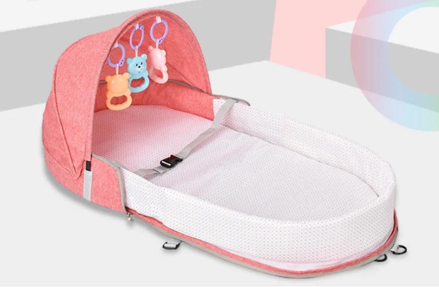 Portable foldable baby anti-mosquito isolation bed with grey cotton linen fabric, open on a grassy area