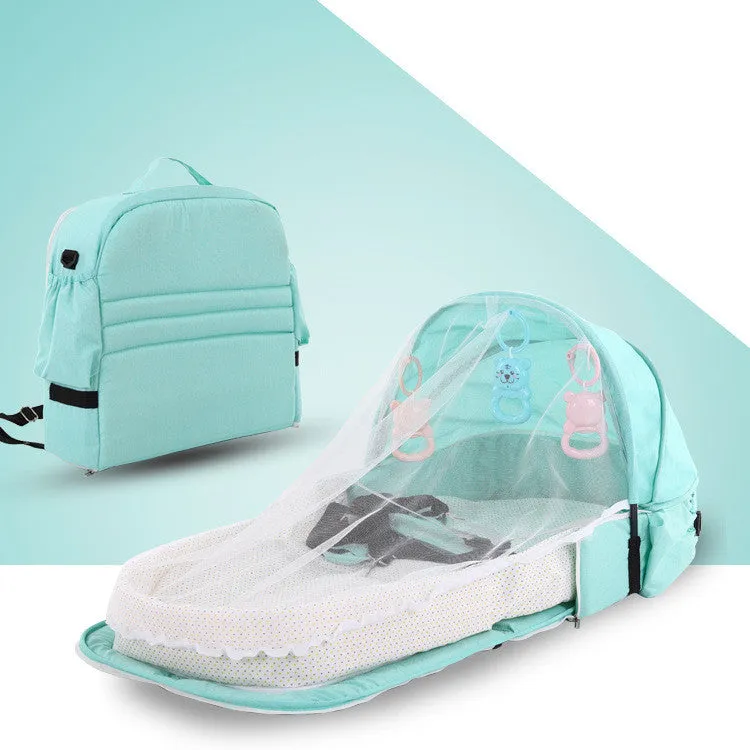 Portable foldable baby anti-mosquito isolation bed with grey cotton linen fabric, open on a grassy area