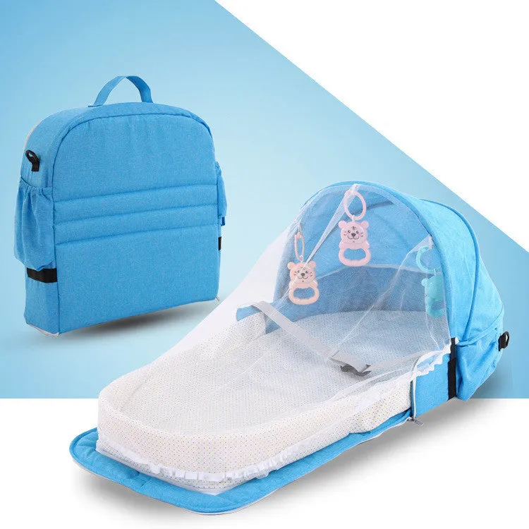 Portable foldable baby anti-mosquito isolation bed with grey cotton linen fabric, open on a grassy area