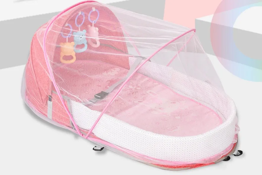 Portable foldable baby anti-mosquito isolation bed with grey cotton linen fabric, open on a grassy area