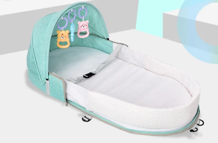 Portable foldable baby anti-mosquito isolation bed with grey cotton linen fabric, open on a grassy area