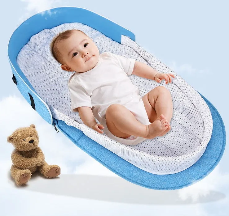 Portable foldable baby anti-mosquito isolation bed with grey cotton linen fabric, open on a grassy area