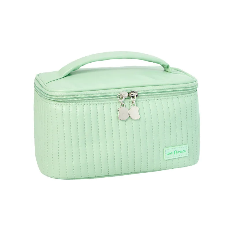 Open-top PU leather makeup bag in a solid colour, showing cosmetics and brushes inside.