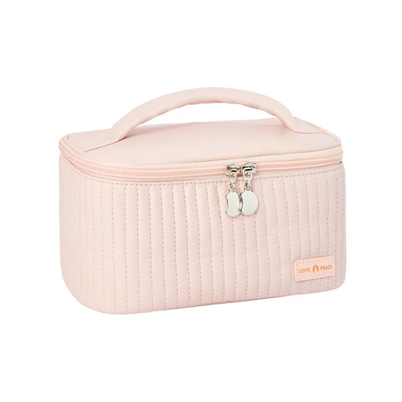 Open-top PU leather makeup bag in a solid colour, showing cosmetics and brushes inside.