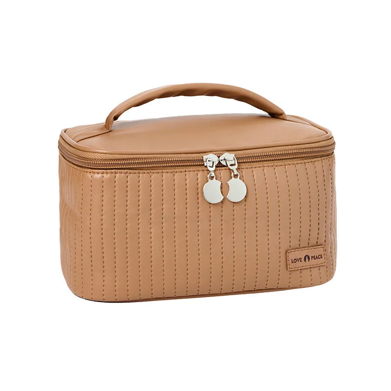 Open-top PU leather makeup bag in a solid colour, showing cosmetics and brushes inside.