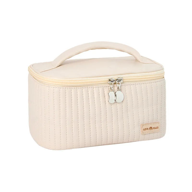 Open-top PU leather makeup bag in a solid colour, showing cosmetics and brushes inside.