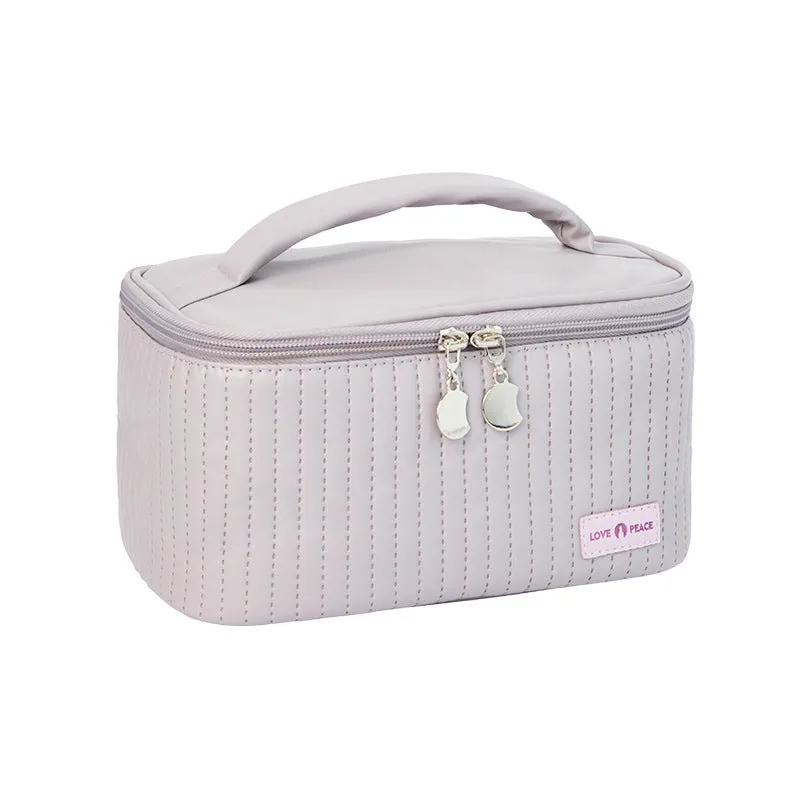 Open-top PU leather makeup bag in a solid colour, showing cosmetics and brushes inside.