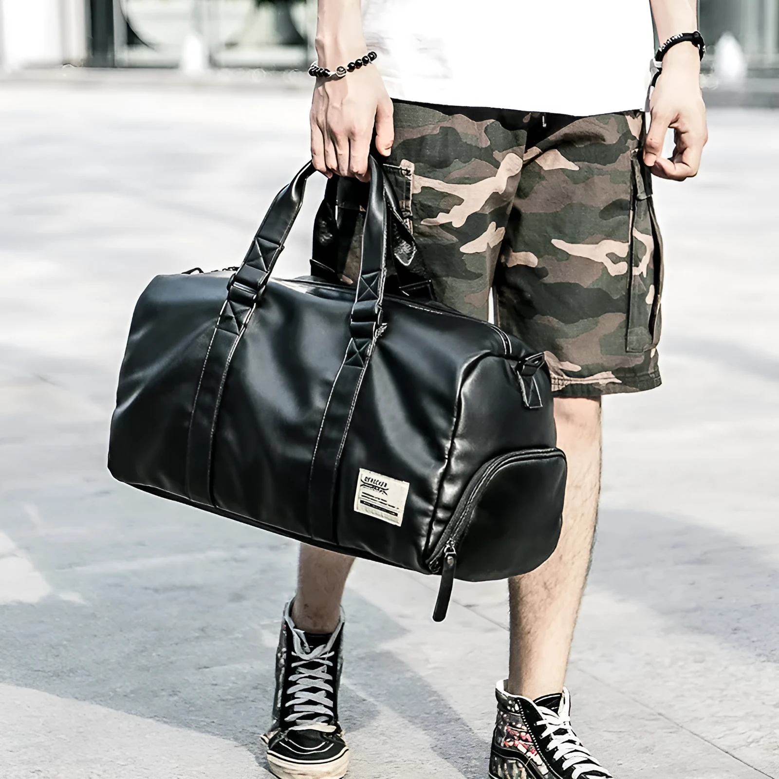 Large black waterproof PU leather sports training bag with multiple pockets and a breathable back panel.