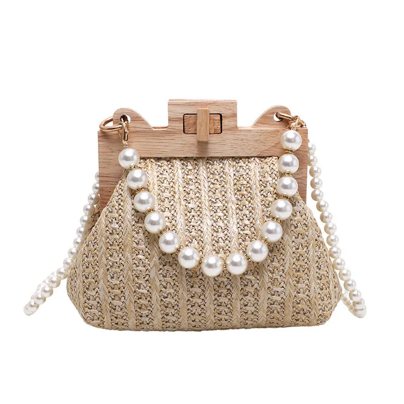 Women's woven straw shoulder bag with pearl chain strap in beige, showing internal organiser pockets.