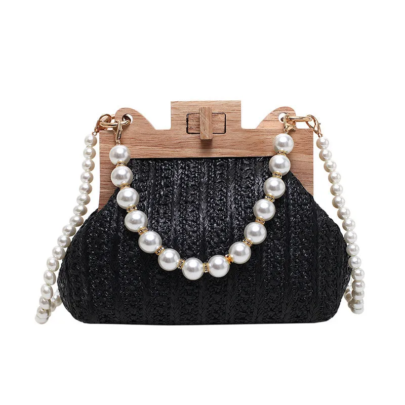 Women's woven straw shoulder bag with pearl chain strap in beige, showing internal organiser pockets.