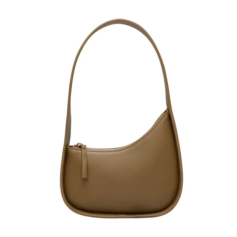 Half moon shaped leather ladies handbag with wide shoulder strap in small size