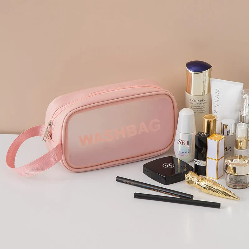 Korean transparent PU waterproof cosmetic bag in cherry pink, medium size, on a white background, showing its cube shape and zip closure.
