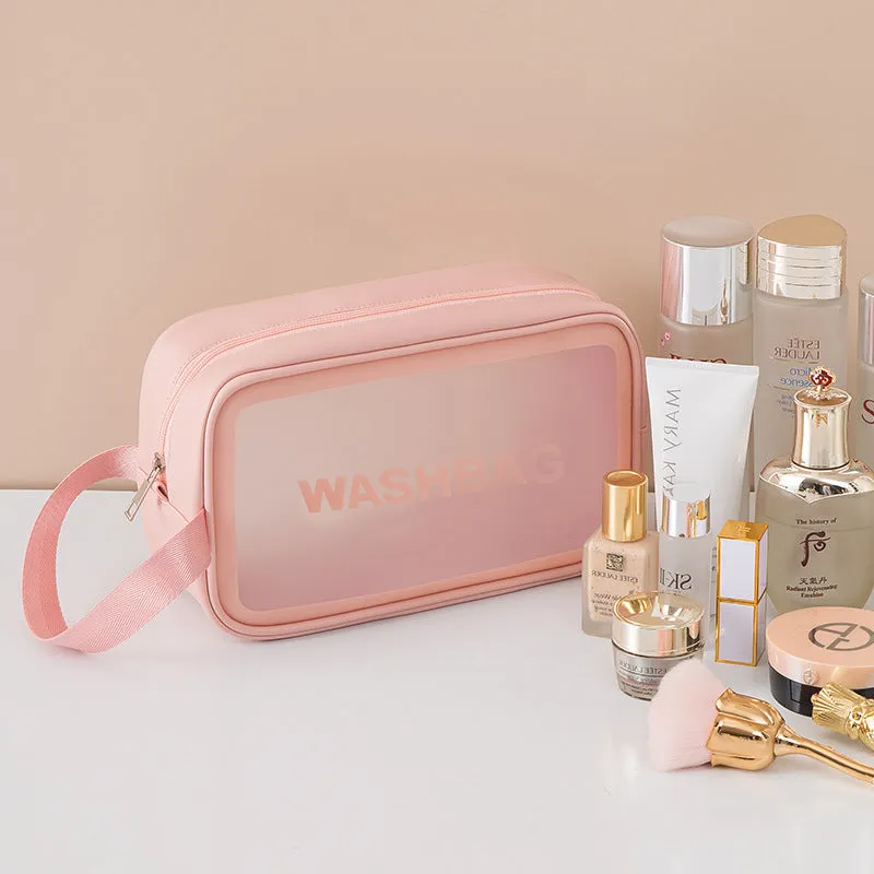 Korean transparent PU waterproof cosmetic bag in cherry pink, medium size, on a white background, showing its cube shape and zip closure.
