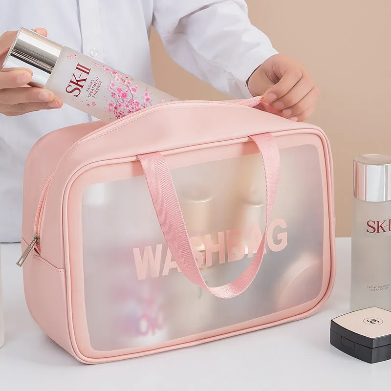 Korean transparent PU waterproof cosmetic bag in cherry pink, medium size, on a white background, showing its cube shape and zip closure.