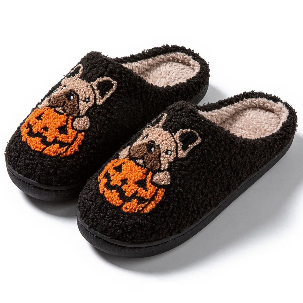 Black and white Halloween slippers with pumpkin pattern, plush upper, and textured rubber sole.