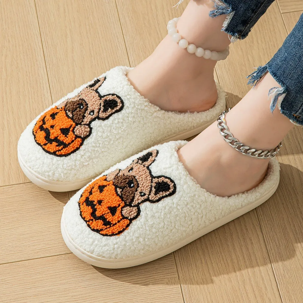 Black and white Halloween slippers with pumpkin pattern, plush upper, and textured rubber sole.