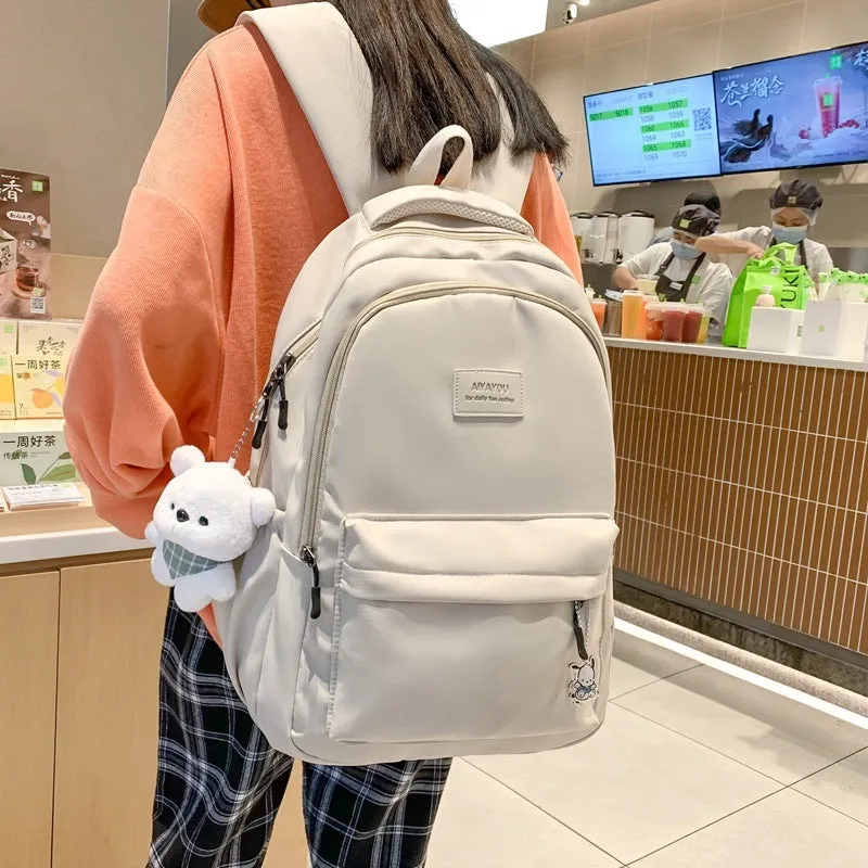 Large capacity nylon backpack for women, waterproof and wear-resistant, in solid colour with zips and straps