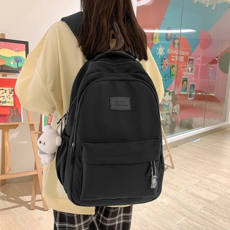 Large capacity nylon backpack for women, waterproof and wear-resistant, in solid colour with zips and straps